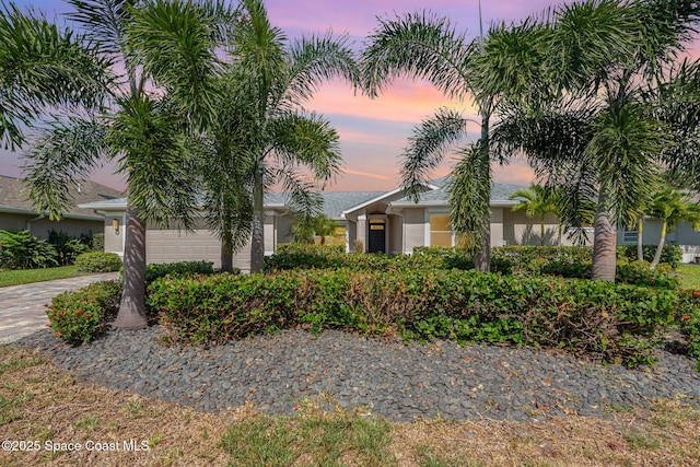 1471 Cypress Trace Dr, Melbourne, FL 32940 - view of front facade with stucco siding, an attached garage, and driveway