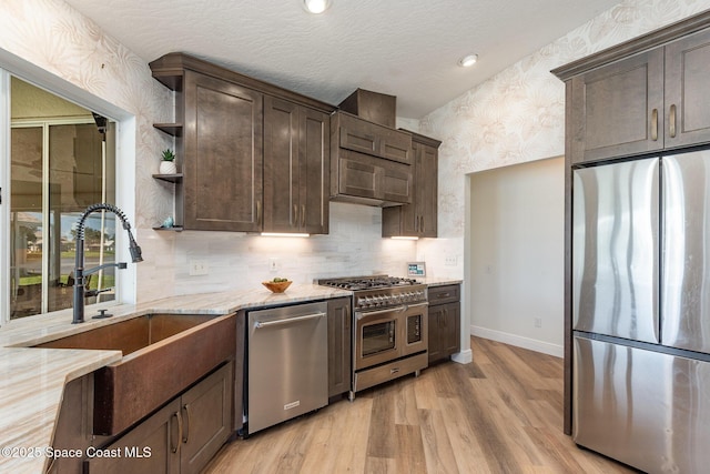 1471 Cypress Trace Dr, Melbourne, FL 32940 - kitchen featuring stainless steel appliances, wallpapered walls, dark brown cabinetry, light stone countertops, and open shelves