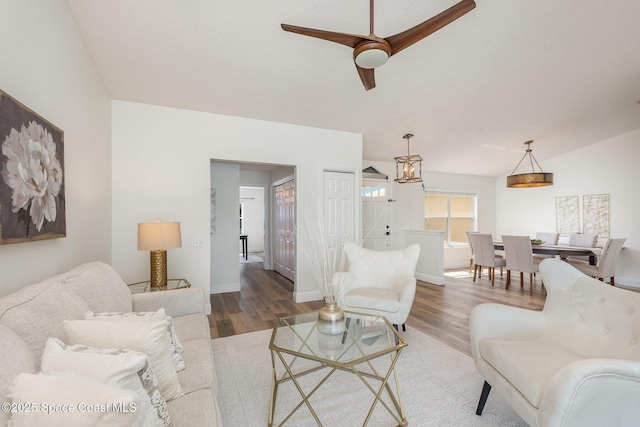 1471 Cypress Trace Dr, Melbourne, FL 32940 - living room with wood finished floors, a ceiling fan, and a chandelier