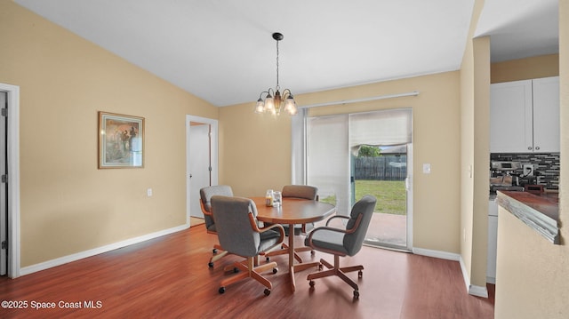 219 Fecco St, Cocoa, FL 32927 - dining space with wood finished floors, a chandelier, and lofted ceiling
