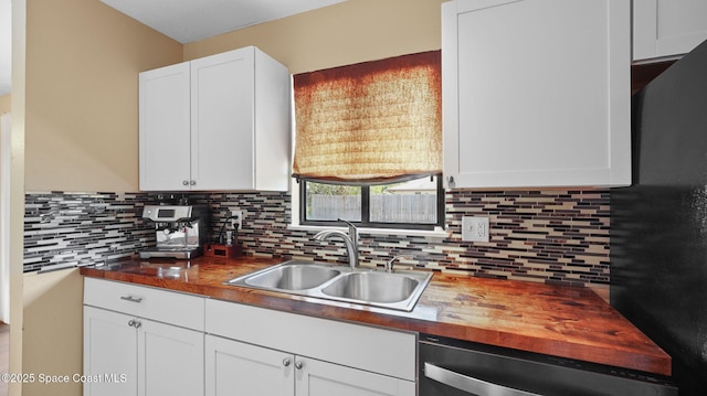 219 Fecco St, Cocoa, FL 32927 - kitchen with dishwasher, butcher block countertops, tasteful backsplash, and white cabinets