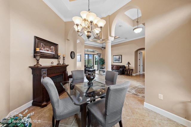 3079 Levanto Dr, Melbourne, FL 32940 - dining room with arched walkways, a chandelier, crown molding, light tile patterned flooring, and a glass covered fireplace