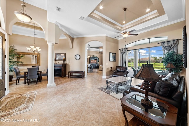 3079 Levanto Dr, Melbourne, FL 32940 - living room with arched walkways, ornate columns, a raised ceiling, crown molding, and ceiling fan