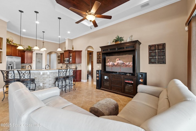 3079 Levanto Dr, Melbourne, FL 32940 - living room with arched walkways, a ceiling fan, light tile patterned flooring, recessed lighting, and ornamental molding
