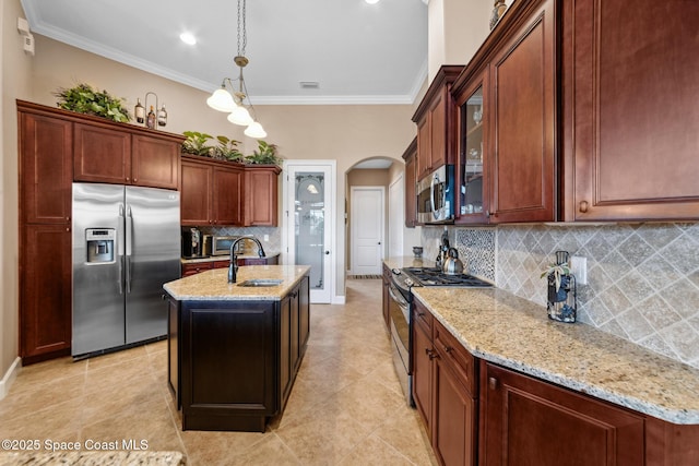 3079 Levanto Dr, Melbourne, FL 32940 - kitchen featuring stainless steel appliances, arched walkways, tasteful backsplash, light stone counters, and ornamental molding