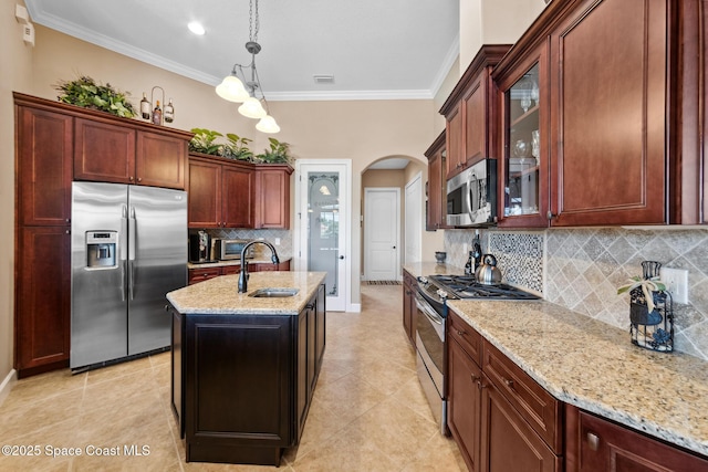 3079 Levanto Dr, Melbourne, FL 32940 - kitchen with stainless steel appliances, arched walkways, light stone countertops, glass insert cabinets, and crown molding