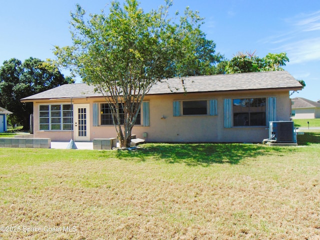 1943 Bradway St NE, Palm Bay, FL 32905 - back of property with a yard and stucco siding