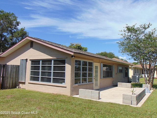 1943 Bradway St NE, Palm Bay, FL 32905 - rear view of house with stucco siding and a patio