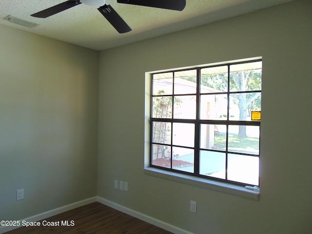 1943 Bradway St NE, Palm Bay, FL 32905 - empty room featuring dark wood finished floors, a textured ceiling, and a ceiling fan