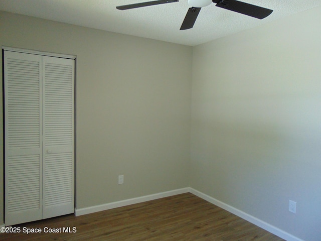1943 Bradway St NE, Palm Bay, FL 32905 - unfurnished bedroom with wood finished floors, a closet, and a ceiling fan