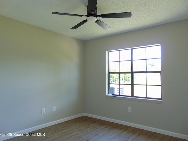 1943 Bradway St NE, Palm Bay, FL 32905 - empty room with wood finished floors, a ceiling fan, and a textured ceiling