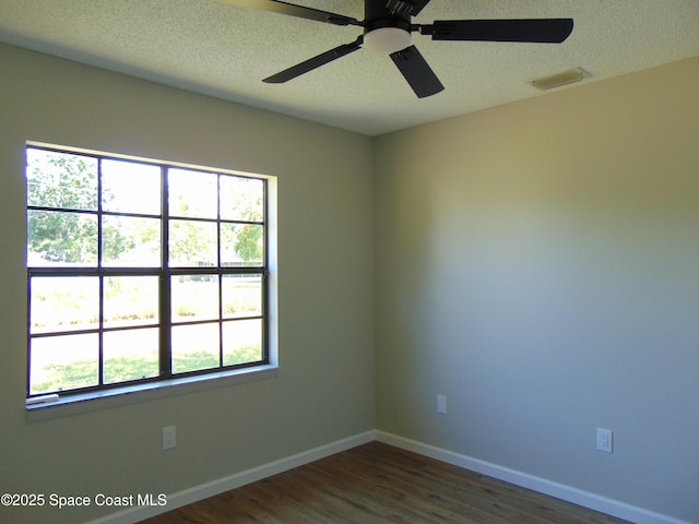 1943 Bradway St NE, Palm Bay, FL 32905 - spare room featuring dark wood-style flooring, ceiling fan, and a textured ceiling