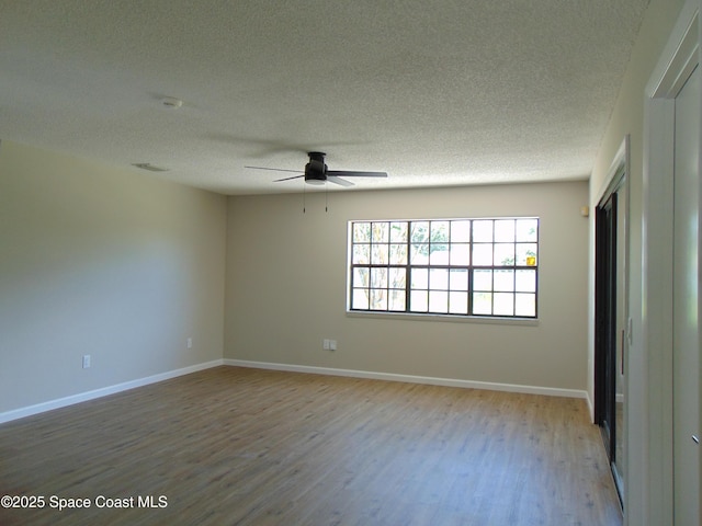 1943 Bradway St NE, Palm Bay, FL 32905 - spare room with wood finished floors, a textured ceiling, ceiling fan, and a smoke detector