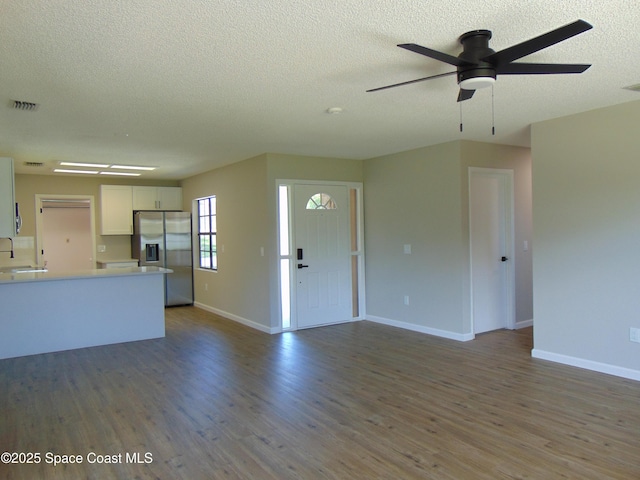 1943 Bradway St NE, Palm Bay, FL 32905 - unfurnished living room with a textured ceiling, a ceiling fan, and wood finished floors