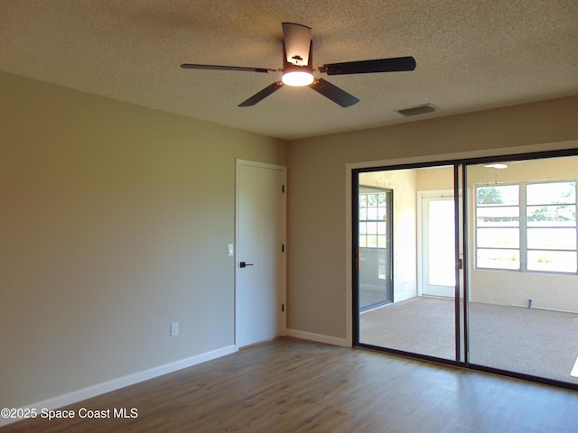 1943 Bradway St NE, Palm Bay, FL 32905 - spare room featuring wood finished floors, a textured ceiling, and a ceiling fan