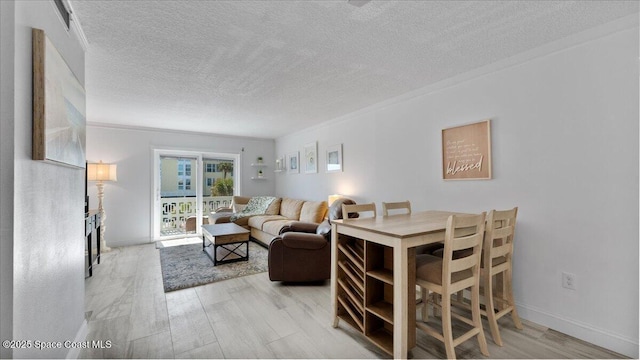 4800 Ocean Beach Blvd Unit 226, Cocoa Beach, FL 32931 - living room featuring a textured ceiling and light wood-style floors