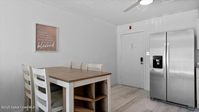 4800 Ocean Beach Blvd Unit 226, Cocoa Beach, FL 32931 - dining area with ceiling fan, crown molding, and light wood-style flooring