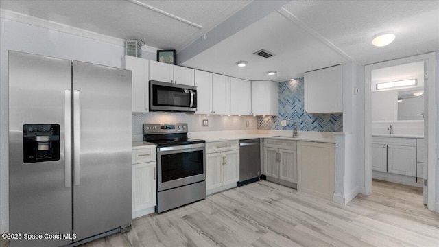 4800 Ocean Beach Blvd Unit 226, Cocoa Beach, FL 32931 - kitchen featuring stainless steel appliances, tasteful backsplash, and light countertops