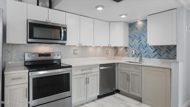 4800 Ocean Beach Blvd Unit 226, Cocoa Beach, FL 32931 - kitchen with appliances with stainless steel finishes, light countertops, tasteful backsplash, and white cabinetry