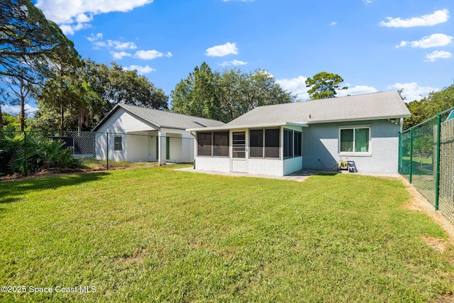 3104 Winchester Dr, Cocoa, FL 32926 - back of property featuring a sunroom, a fenced backyard, stucco siding, and a shingled roof