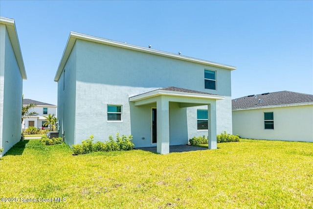 3538 Angler Dr, Ft Pierce, FL 34947 - rear view of house with stucco siding, a yard, and a patio