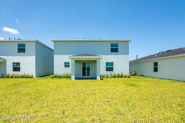 3538 Angler Dr, Ft Pierce, FL 34947 - back of house featuring a yard and stucco siding
