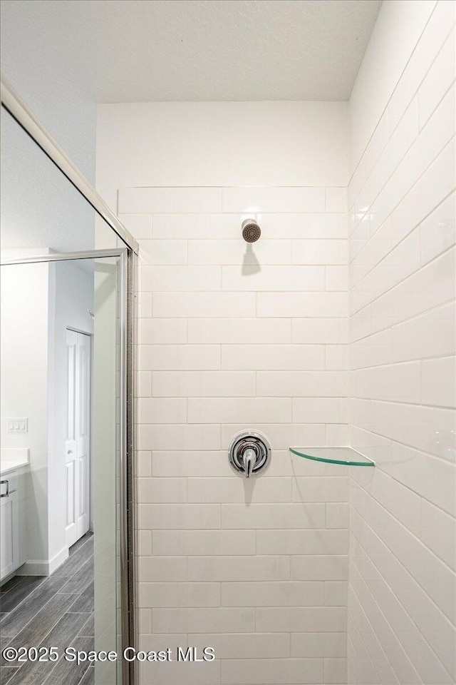 3538 Angler Dr, Ft Pierce, FL 34947 - bathroom featuring a shower stall, wood finished floors, and vanity