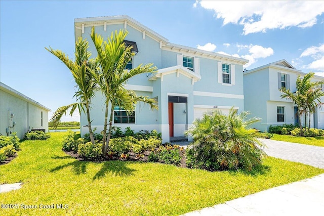 3538 Angler Dr, Ft Pierce, FL 34947 - view of front facade with a front lawn, stucco siding, and driveway