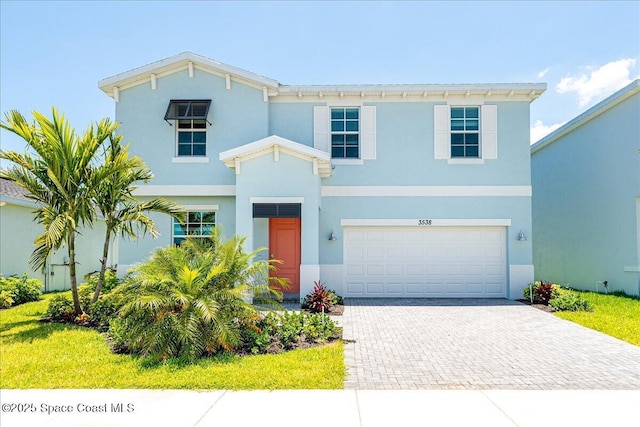 3538 Angler Dr, Ft Pierce, FL 34947 - italianate house with decorative driveway, stucco siding, and a garage
