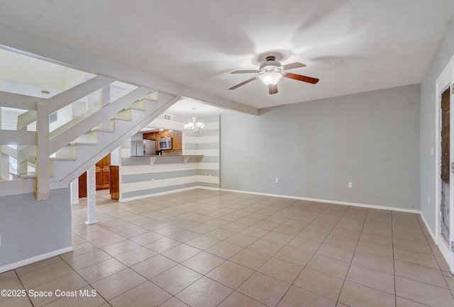 53 Emerald Ct, Satellite Beach, FL 32937 - unfurnished living room featuring light tile patterned floors, a ceiling fan, a chandelier, and stairway