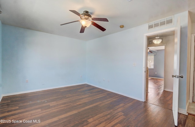 53 Emerald Ct, Satellite Beach, FL 32937 - unfurnished room featuring a ceiling fan and dark wood-type flooring
