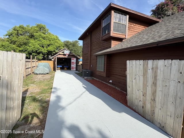 6860 Cairo Rd, Cocoa, FL 32927 - view of property exterior featuring a shingled roof and an outdoor structure