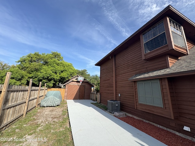 6860 Cairo Rd, Cocoa, FL 32927 - view of property exterior with a storage shed and roof with shingles
