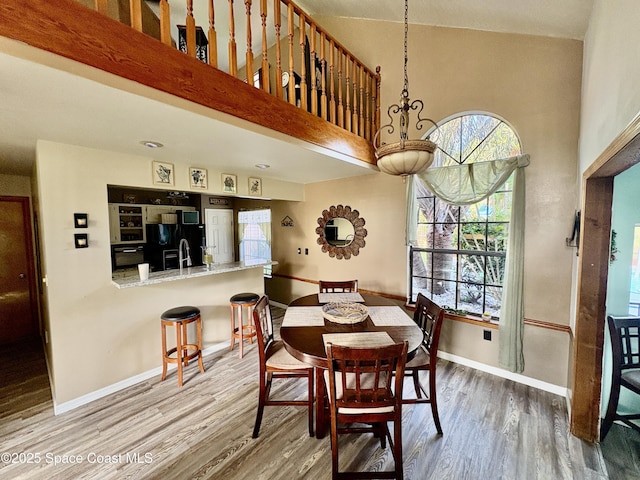 6860 Cairo Rd, Cocoa, FL 32927 - dining room featuring wood finished floors and a high ceiling