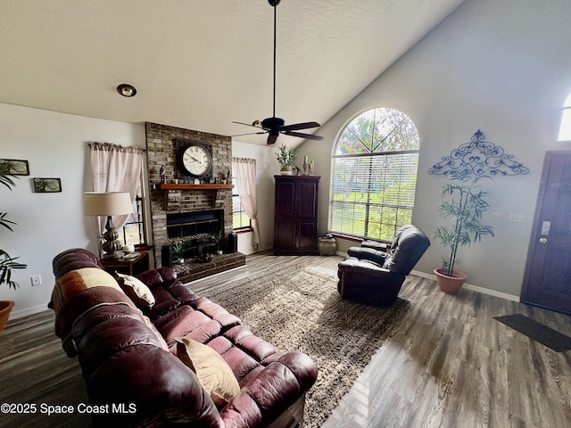 6860 Cairo Rd, Cocoa, FL 32927 - living area with a fireplace, a ceiling fan, vaulted ceiling, and wood finished floors