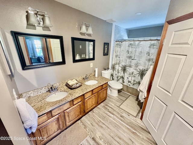 6860 Cairo Rd, Cocoa, FL 32927 - full bathroom with double vanity, a shower with shower curtain, and wood finished floors