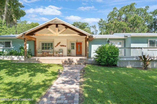 2310 Bignonia St, Melbourne, FL 32901 - ranch-style home featuring a front lawn, a porch, and stucco siding