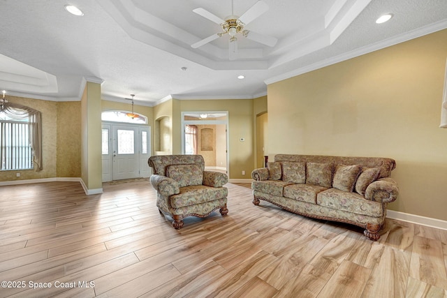2604 Canary Isles Dr, Melbourne, FL 32901 - living room with a tray ceiling, wood finished floors, a ceiling fan, ornamental molding, and recessed lighting