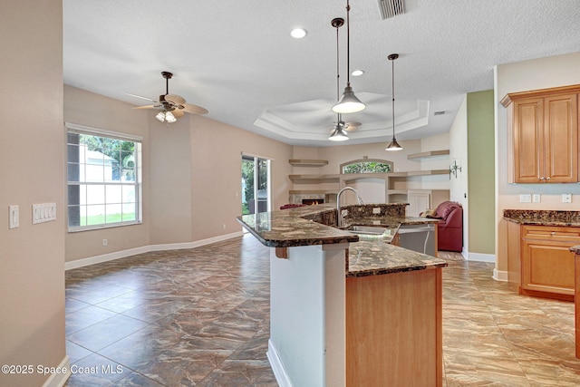 2604 Canary Isles Dr, Melbourne, FL 32901 - kitchen with open floor plan, ceiling fan, plenty of natural light, a tray ceiling, and a textured ceiling