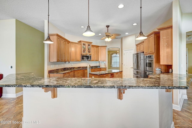 2604 Canary Isles Dr, Melbourne, FL 32901 - kitchen with a kitchen breakfast bar, stainless steel appliances, a ceiling fan, a peninsula, and recessed lighting