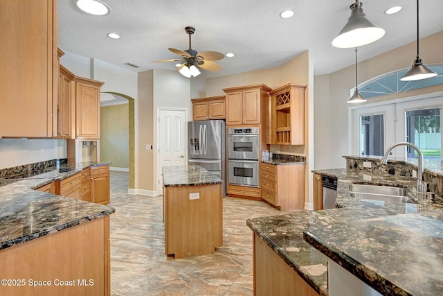 2604 Canary Isles Dr, Melbourne, FL 32901 - kitchen featuring appliances with stainless steel finishes, a kitchen island, arched walkways, open shelves, and a ceiling fan