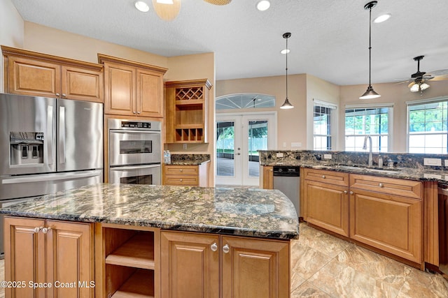 2604 Canary Isles Dr, Melbourne, FL 32901 - kitchen with open shelves, appliances with stainless steel finishes, ceiling fan, french doors, and dark stone countertops