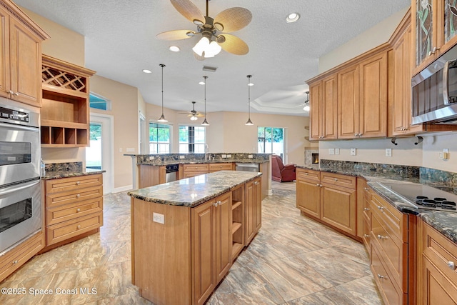 2604 Canary Isles Dr, Melbourne, FL 32901 - kitchen with open shelves, ceiling fan, a kitchen island, stainless steel appliances, and a textured ceiling