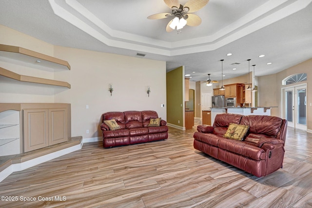 2604 Canary Isles Dr, Melbourne, FL 32901 - living room featuring ceiling fan, a raised ceiling, recessed lighting, and french doors