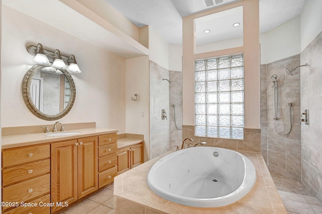2604 Canary Isles Dr, Melbourne, FL 32901 - bathroom featuring a jetted tub, walk in shower, vanity, tile patterned floors, and recessed lighting