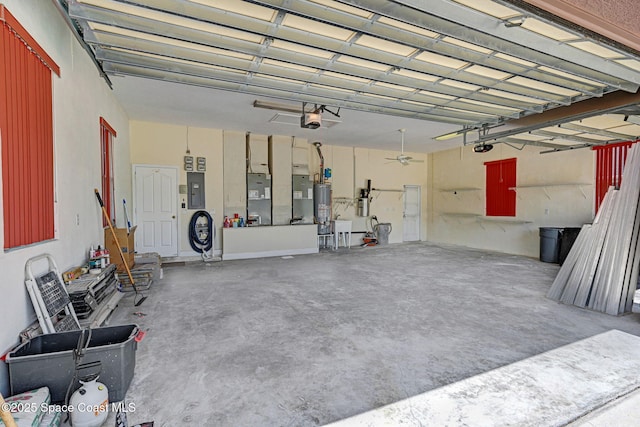 2604 Canary Isles Dr, Melbourne, FL 32901 - garage featuring gas water heater, a garage door opener, and electric panel