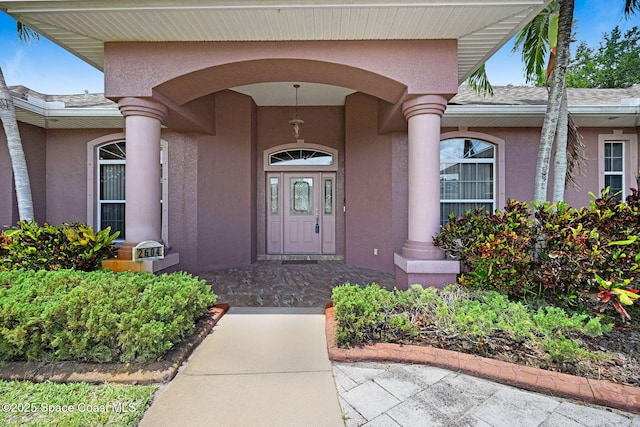 2604 Canary Isles Dr, Melbourne, FL 32901 - doorway to property featuring stucco siding and covered porch