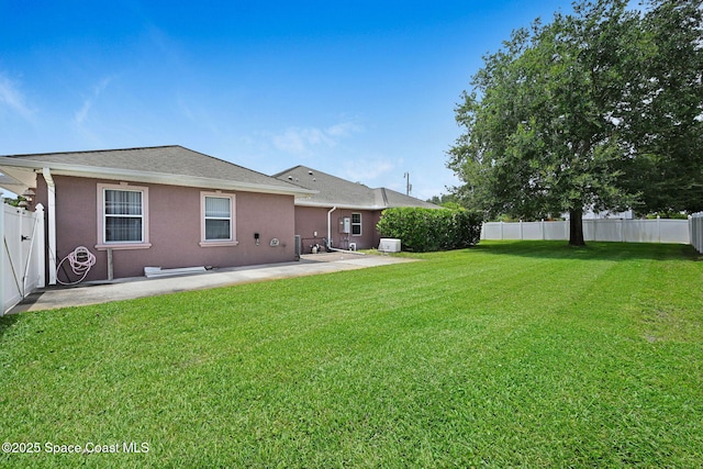 2604 Canary Isles Dr, Melbourne, FL 32901 - back of property with a patio area, a fenced backyard, stucco siding, and a shingled roof