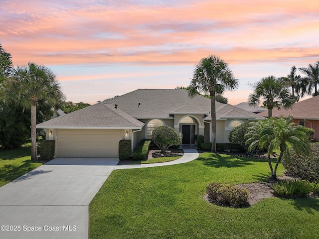 1526 Cypress Trace Dr, Melbourne, FL 32940 - ranch-style home with a garage, a lawn, stucco siding, concrete driveway, and roof with shingles