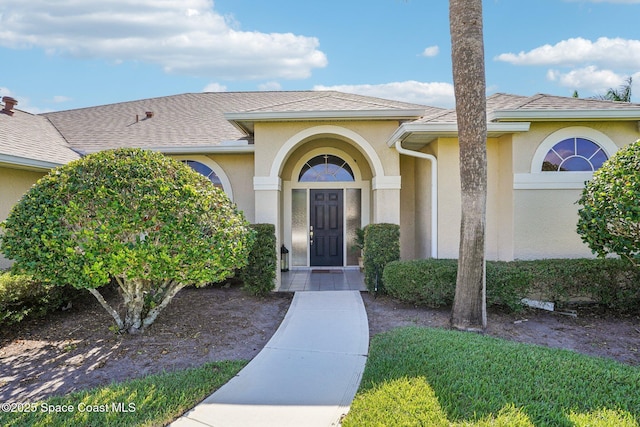 1526 Cypress Trace Dr, Melbourne, FL 32940 - doorway to property with stucco siding and a shingled roof